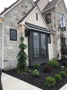 a house that has some plants in front of it