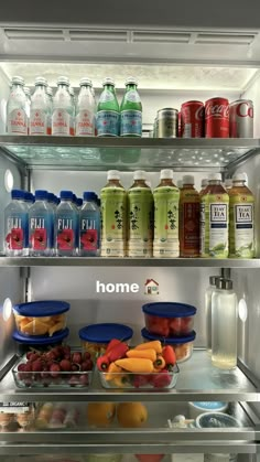 an open refrigerator filled with lots of different types of drinks and food in it's shelves