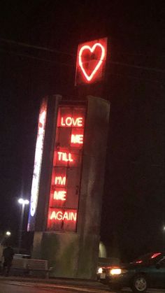 a neon sign that says love me, tell me again and i'm against it