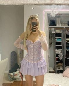 a woman in a corset taking a selfie while standing on a bed