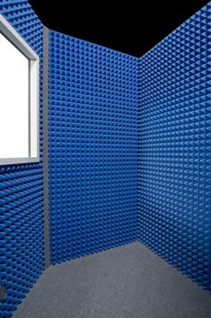 an empty room with blue plastic bricks covering the walls