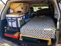 there is a bed in the back of an suv