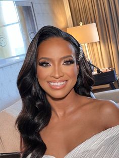 a woman in a white dress smiling at the camera