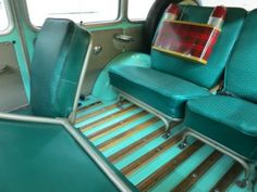 the interior of an old bus with green seats