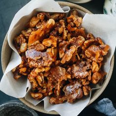 a bowl filled with nuts sitting on top of a table