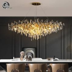 an elegant chandelier hangs over a dining room table with brown leather chairs and white marble top