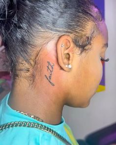 a woman with a tattoo on her left ear