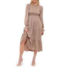 The August Sky Women's Smocked Body Long Sleeves Midi Dress combines elegance and comfort. It features a round neckline with a behind-the-neck button and keyhole for a delicate touch. The smocked bodice provides a flattering and snug fit, complemented by a tiered skirt that adds graceful movement. Constructed from satin-like fabric, this dress has a luxurious feel and is fully lined to ensure comfort and coverage. Perfect for any special occasion, this midi dress effortlessly enhances your style Beige Long Sleeve Smocked Dress, Cream Long-sleeved Dress With Smocked Bodice, Long Sleeve Smock Beige Dress, Cream Midi-length Smocked Dress, Chic Long-sleeved Smocked Dress With Ruffle Hem, Wedding Guest Dress Midi, Short Tunic, Graceful Movement, Maxi Slip Dress