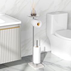 a white toilet sitting next to a sink and a bath tub in a room with marble walls