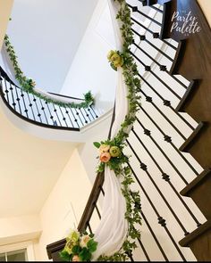 a staircase decorated with flowers and greenery