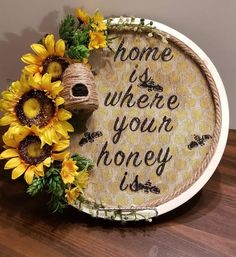 the sunflowers are sitting in front of a sign that says, home is where your honey is