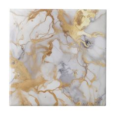 a marble tile with gold and white designs on the bottom, it looks like an abstract piece of art