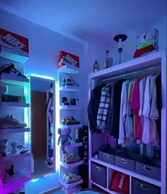 a bedroom with blue lights and clothes on the shelves, in front of a mirror