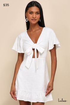 Warmer weather has us planning all the cute places we'll wear the Lulus Adorable Sensibility White Cutout Tie-Front Ruffled Mini Dress! Lightweight, slightly textured woven fabric shapes this charming dress that has short flutter sleeves and a tie-front bodice with a V-neckline and a flirty cutout detail. Matching V-back secures with a slender tie at the top. Fitted waist sits above a lightly flared skirt with ruffled trim and a mini hem. Hidden zipper/clasp at back. Fit: This garment fits true to size. Length: Mid-thigh. Size medium measures 33.5" from shoulder to hem. Bust: Great for any cup size. Waist: Fitted - very fitted at natural waist. Hip: Not Fitted - fuller skirt allows room for hips. Undergarments: May be worn with petals, or no bra. Fabric: Fabric has no stretch. Dress is lin Cute Places, Ruffled Mini Dress, Ruffle Mini Dress, Stretch Dress, Flared Skirt, Cup Size, Flutter Sleeves, Full Skirt, Flare Skirt