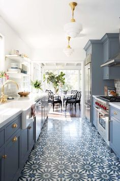 a kitchen with blue cabinets and white counter tops