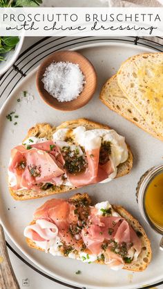 two pieces of bread with meat and cheese on them next to a cup of tea