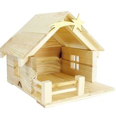 a wooden toy house with a star on the roof