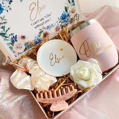 a gift box with personalized items in it on a pink cloth covered tablecloth