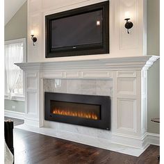 a white fireplace with a flat screen tv above it