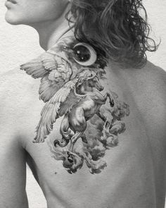 the back of a woman's neck with an image of horses and birds on it