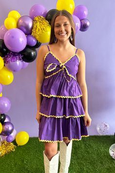 Unleash your game day chic with this purple tiered dress! Featuring bright yellow ric rac trim, adjustable spaghetti straps, and a bust-tying design, this dress is both cute and practical. Perfect for cheering on your team in style. Ecu Pirates, Denim Jewelry, Peach Love, Ric Rac, Tiered Dress, New Arrival Dress, Bright Yellow, Purple Dress, Game Day