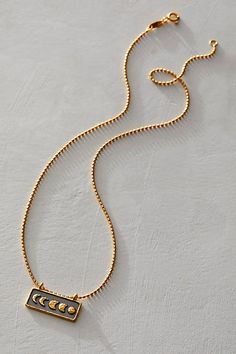 Lovely for layering up or simply styling solo, this stunning necklace features an 18k gold plated bar with the phases of the moon against a gunmetal background. * Moon - nourishment, protection, goddess * Pendant size - 10 x 24mm * Necklace length - 18" * Closure type - spring ring * 18kt gold plate over brass | Satya Jewelry Self Evolution Necklace at Free People in Gold Self Evolution, Background Moon, The Phases Of The Moon, Satya Jewelry, Goddess Pendant, Phases Of The Moon, Accessories Jewelry Necklace, Stunning Necklace, Necklace Length