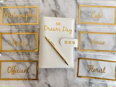 a notebook with gold lettering on it next to some clear plastic boxes that say our dream day