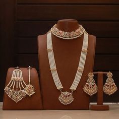 Giving out an elegant vibe owing to its sparking stone mix! A versatile set encrusted with Navratan stones and pearl moti. The set includes a pair of beautiful earrings, jhoomar, tika, necklace and mala. Gold-plated on high-quality brass as base metal. Approximate earrings length is 3.5″. Luxury 22k Gold Bridal Necklace With Stone Work, Luxury Gold Plated Bridal Earrings With Meenakari, Luxury Meenakari Temple Jewelry Pearl Earrings, Pearl Chandbali Sets With Stone Work, Festive Pearl Chandbalis For Wedding, Festive Bollywood Bridal Sets With Pearls, Pearl Sets With Stone Work For Celebration, Festive Pearl Bridal Sets In Temple Jewelry Style, Celebration Pearl Sets With Stone Work