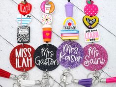 several key chains with different designs and words on them, including one for each teacher