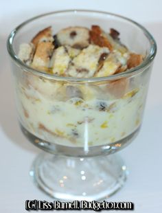 a glass bowl filled with food sitting on top of a table