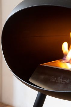 a close up of a fire burning in a fireplace with flames coming out of it