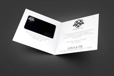 a black and white business card is open