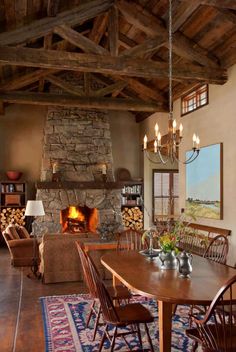 a dining room table with chairs and a fire place in the middle of the room