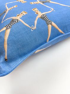 a blue pillow with two women on it