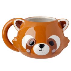 a ceramic mug with a brown and white bear face