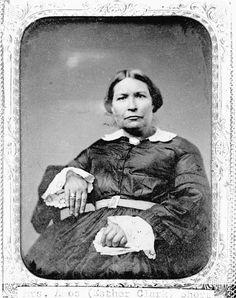 an old black and white photo of a woman