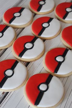 decorated cookies with red and white frosting are arranged in the shape of a pikachu