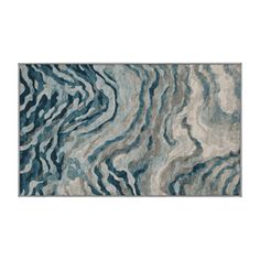 a blue and white rug with wavy lines on it's surface, in the shape of waves