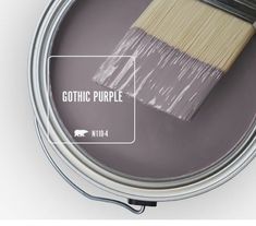 a paint can with a brush in it and the words gothic purple painted on it