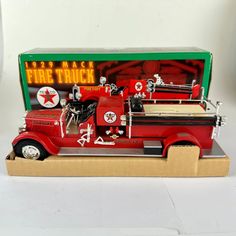 an old model fire truck is on display in a cardboard box with its lid open