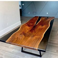 a wooden table sitting on top of a hard wood floor