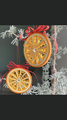 two orange slices hanging from a christmas tree