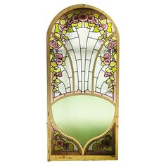 an old stained glass window with flowers on the front and side panels in yellow, green, pink and white colors