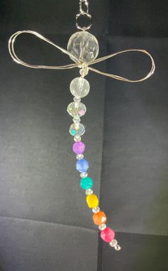 a glass beaded necklace hanging from a chain