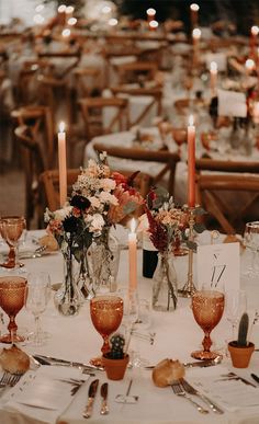 the table is set with candles and flowers