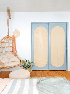 a bedroom with a hammock hanging from the ceiling and a bed in front of it