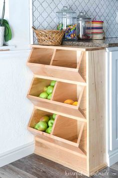 a wooden shelf filled with apples on top of a kitchen counter