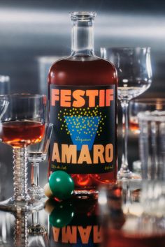 a bottle of amaro next to some wine glasses