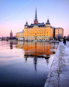 a large building sitting next to a body of water