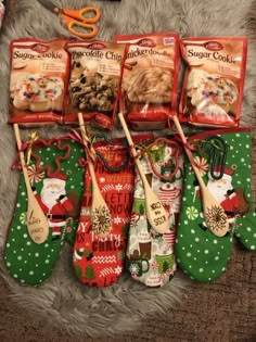 six christmas stockings are lined up on the floor next to some scissors and other items